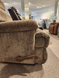 Side view of the La-Z-Boy 519 Astor Rocker Recliner, a tall brown fabric chair with a wood lever in a showroom.