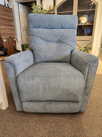 A Palliser 43003 Denali Swivel Power Glider in gray sits on a brown carpet, ideal for any living room display.