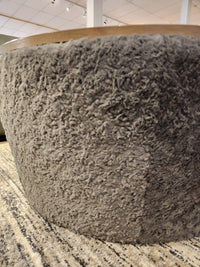 A close-up of the Decor-rest 6415 Lift Top Storage Ottoman/Coffee Table on a patterned rug in a showroom.