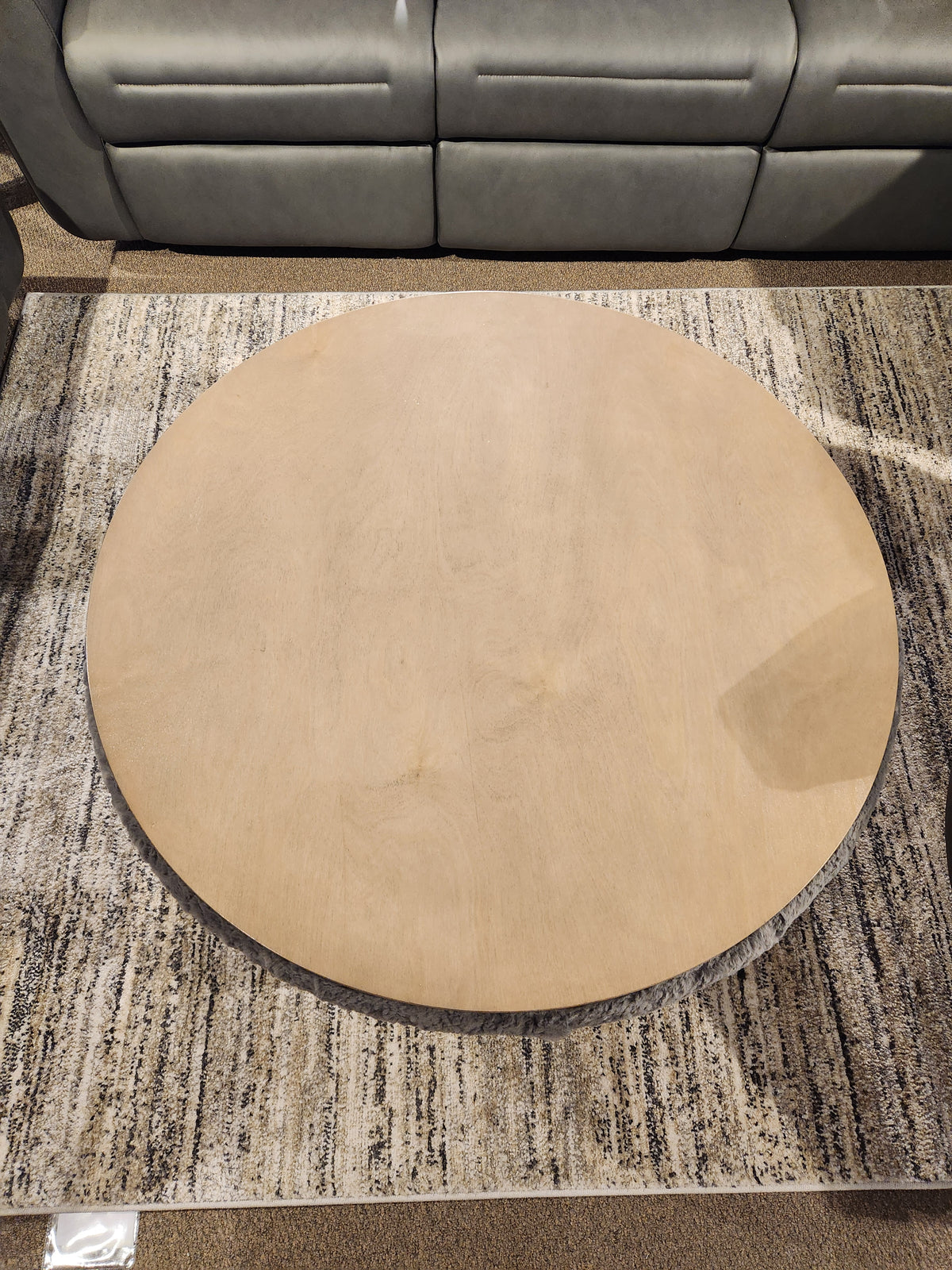 A Decor-rest 6415 Lift Top Storage Ottoman/Coffee Table sits on a textured rug in front of a gray sofa.