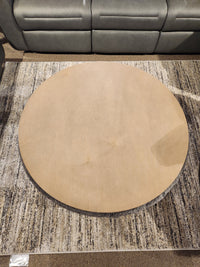 A Decor-rest 6415 Lift Top Storage Ottoman/Coffee Table sits on a textured rug in front of a gray sofa.