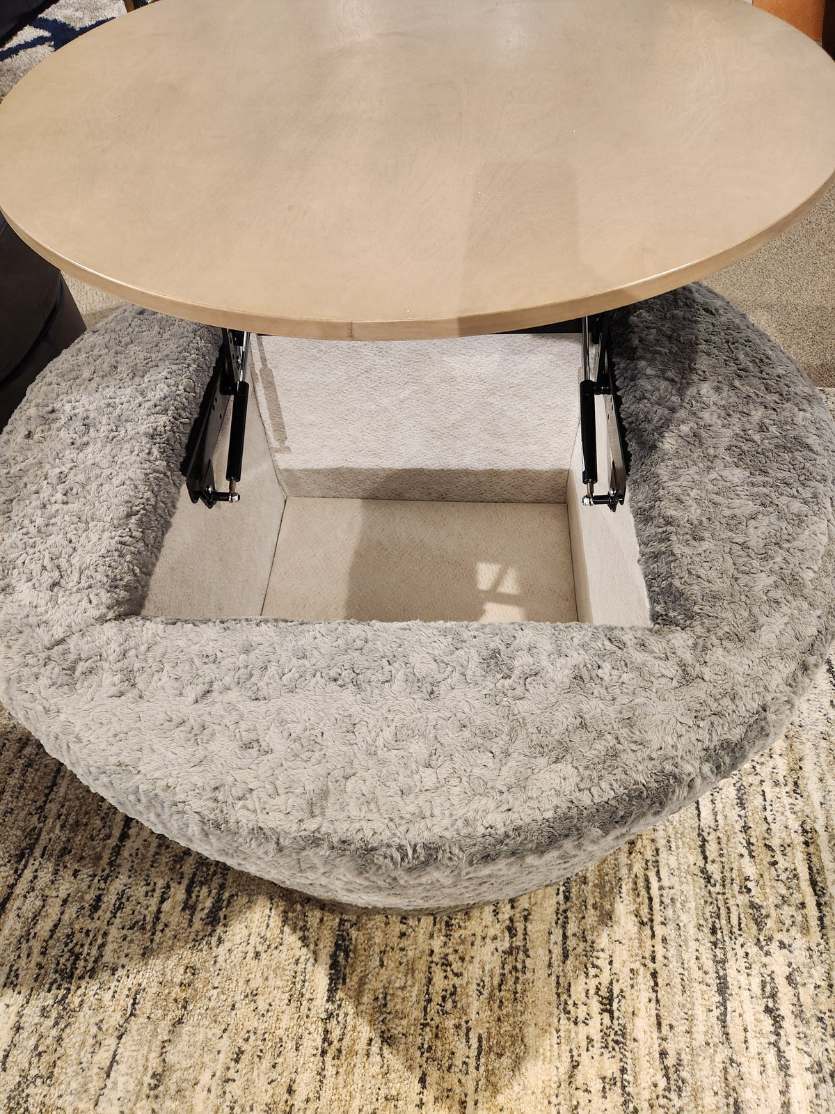 The Decor-rest 6415 Lift Top Storage Ottoman/Coffee Table features a gray textured finish and hidden storage inside.