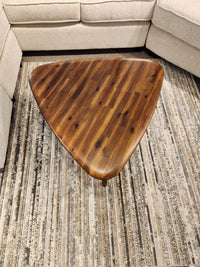 The 7110 Kacia Tri Coffee Table by Palliser sits on a patterned rug between sections of a beige sofa.