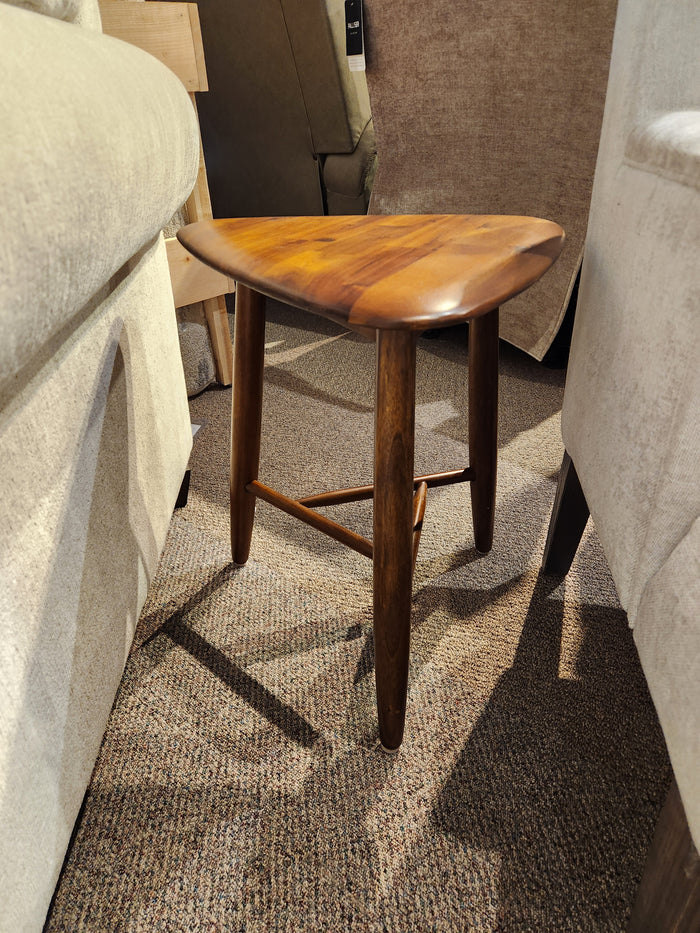 The Palliser 7110 Kacia Tri end Table in solid acacia wood sits on carpet between upholstered chairs.