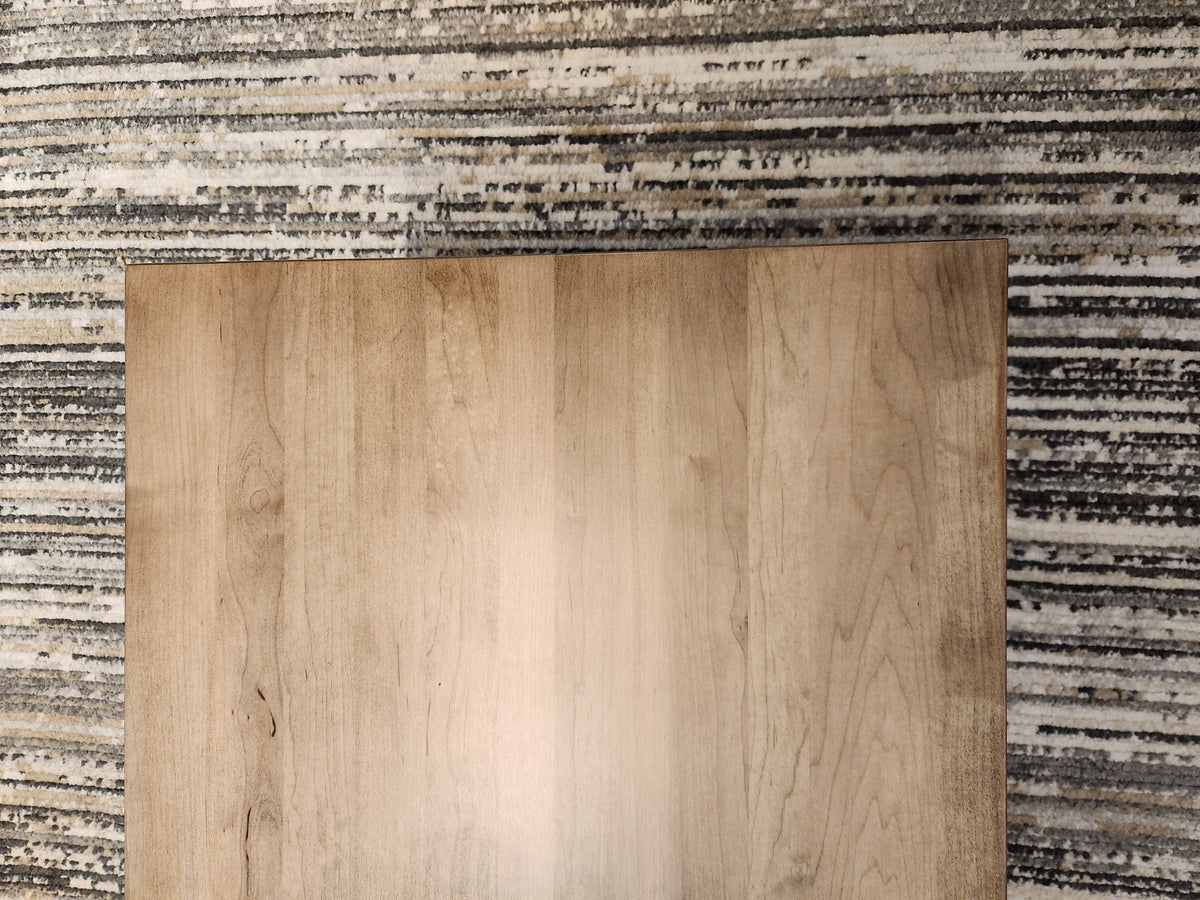 A Durham 905-2 Drawer 48x24" Cocktail Table in Champagne sits on a gray and white striped carpet.