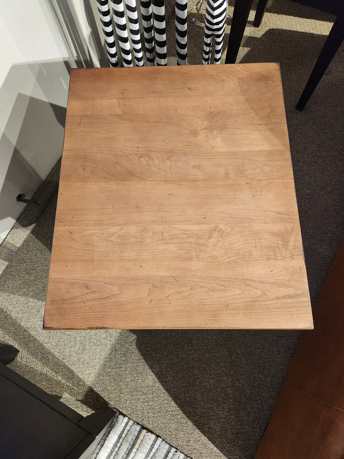 Durham 905 20"x24" End Table in Aged Wheat, rectangular and modern, sits on carpeted floor near chairs.