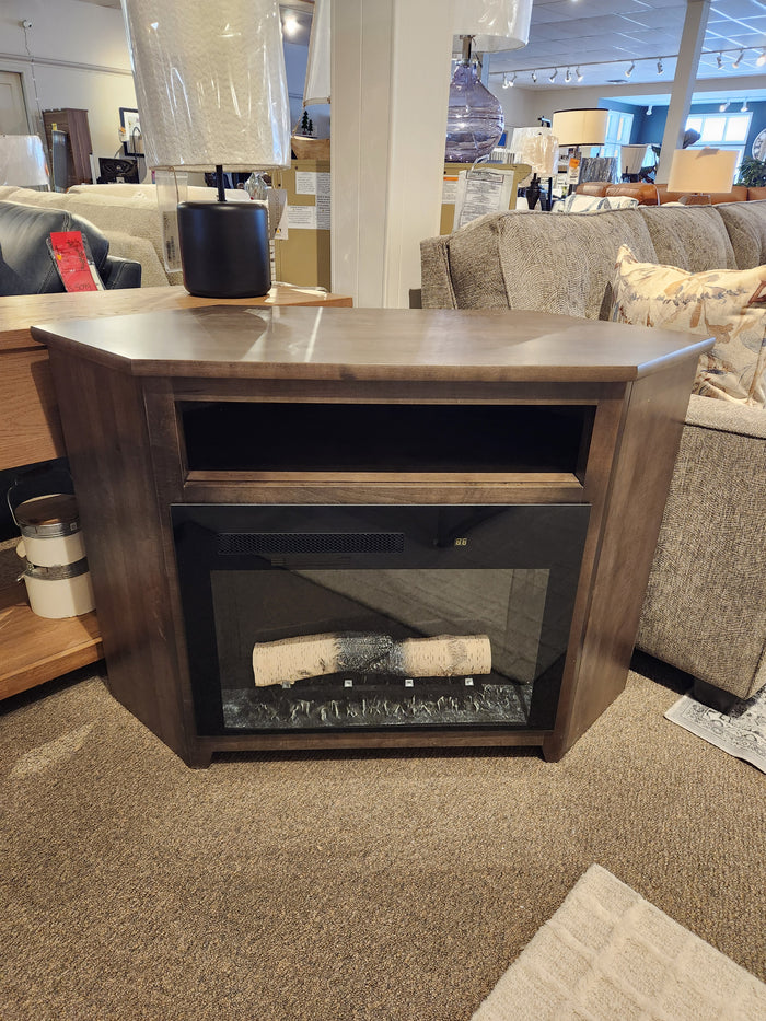 Durham 905-Open Corner Cabinet With Logs in Firebox, showcased in a wood corner cabinet showroom.