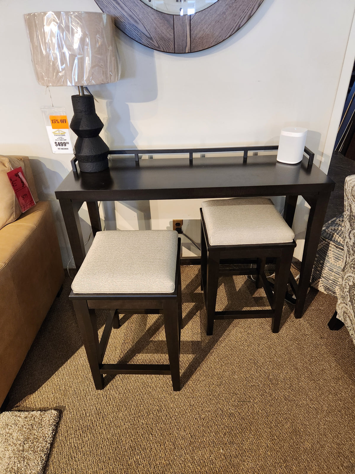 The Durham 905 Console Table w/Metal Rail includes two cushioned stools, ideal for modern spaces. Lamp and speaker shown.