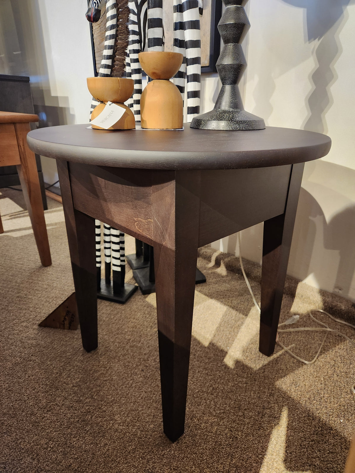 The Durham 905-24" Round Table in Java features three tapered legs; perfect for compact spaces and styling décor.