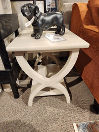 The Durham 900-534 Transitional End Table features X-legs, a lower shelf, and fits perfectly beside an orange sofa.