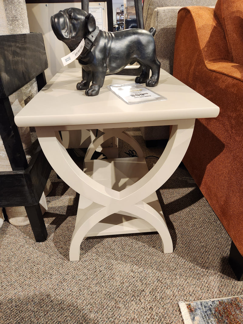The Durham 900-534 Transitional End Table features X-legs, a lower shelf, and fits perfectly beside an orange sofa.