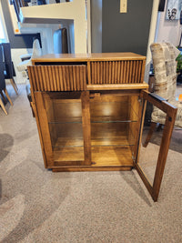 The Handstone Lotus Dining Sideboard features two drawers, glass doors, two interior shelves, and built-in pot lights.