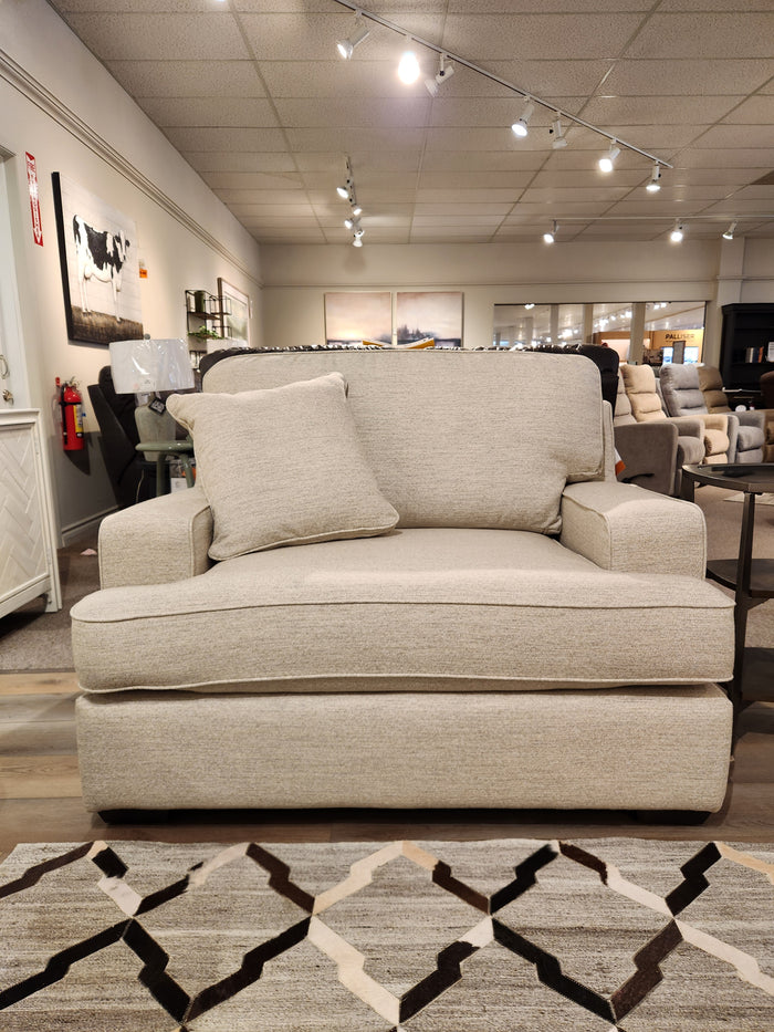 The La-z-boy 663 Paxton Chair & 1/2 with ComfortCore offers casual style seating in a showroom with art and lighting overhead.