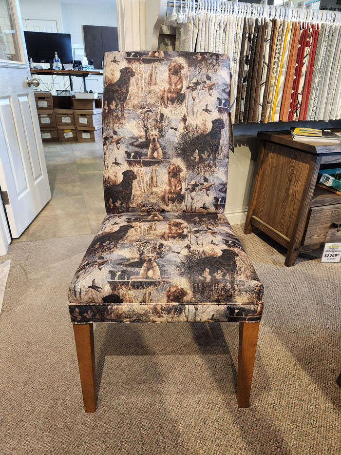 Best FS9800 Odell dining chair with wooden legs, hunting dog and duck fabric, displayed in showroom.