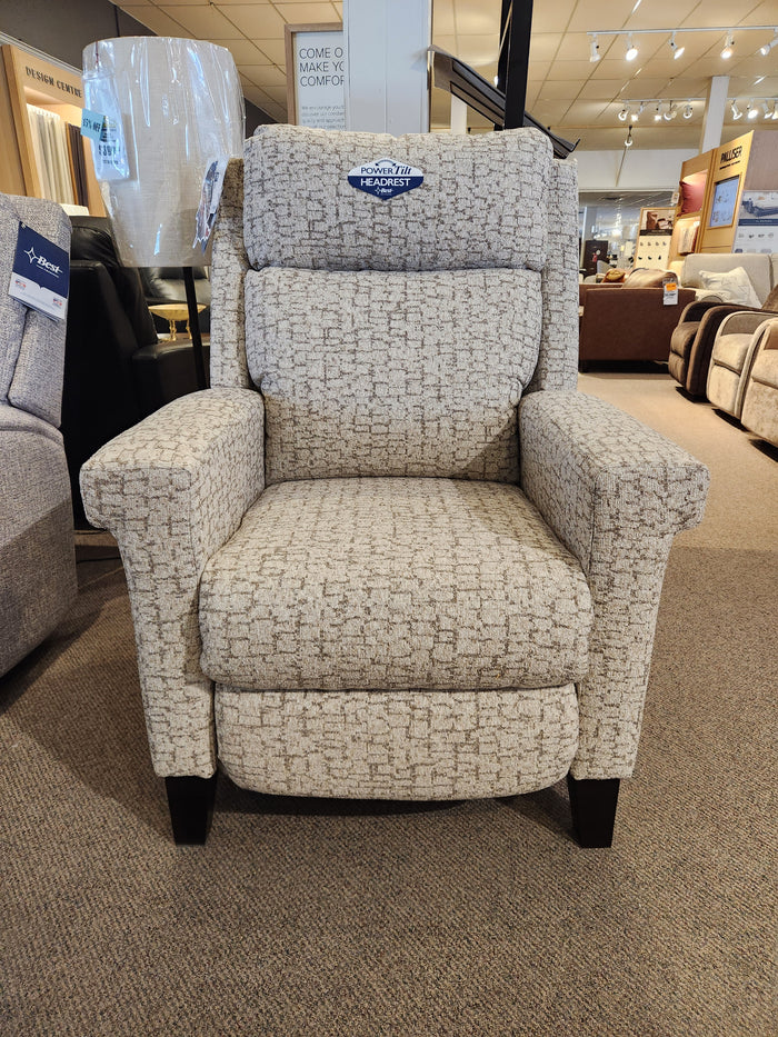 The Best 3LZ40E Prima High-Leg Recliner in beige textured fabric is displayed in a furniture showroom.
