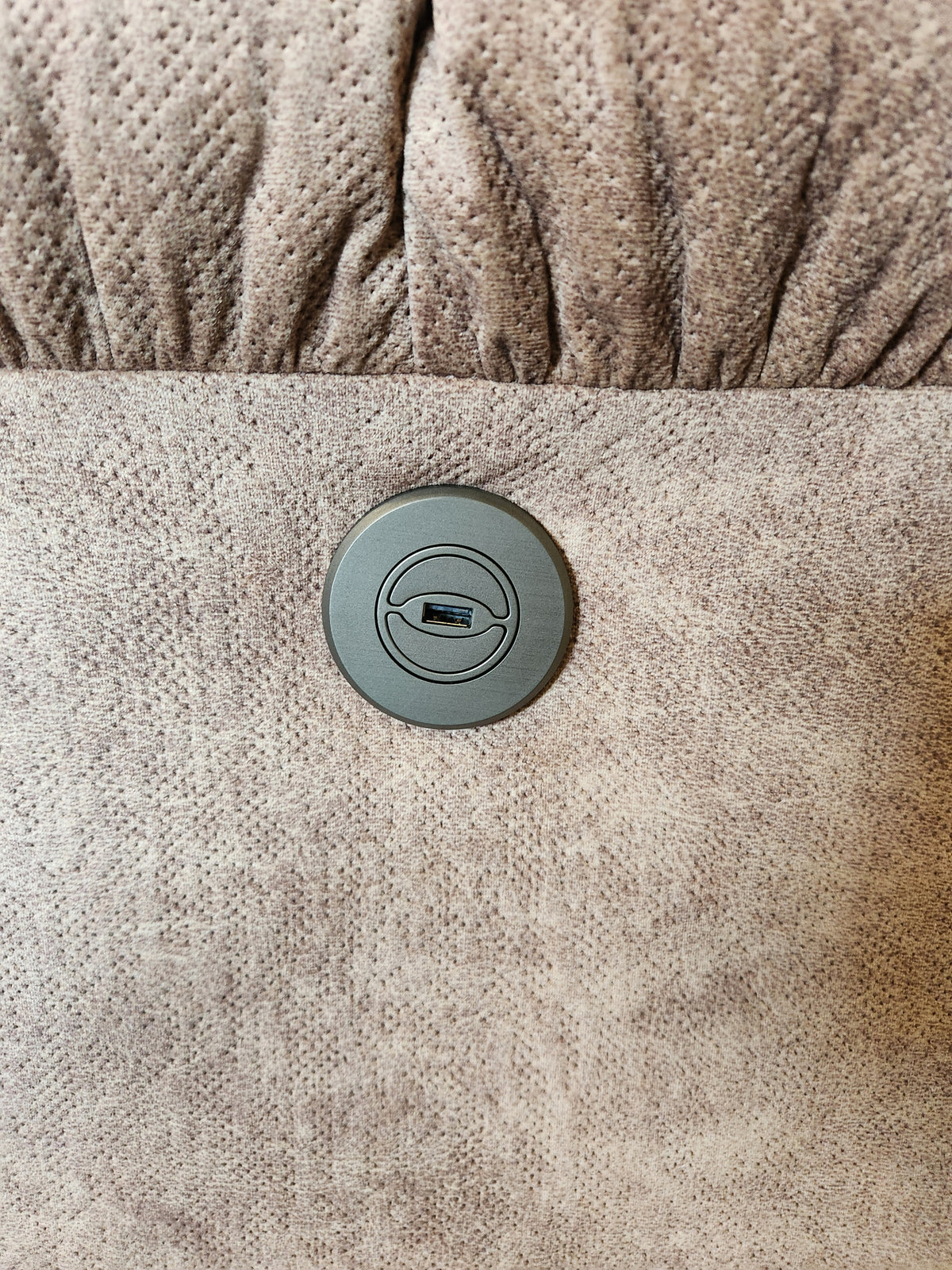 Close-up of a USB port on the textured surface of the Best 7MP84 Ellisport Power Space Saver Recliner.