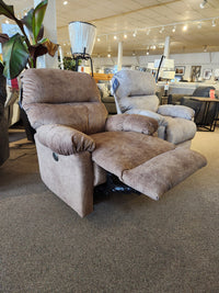 The Best 7MP84 Ellisport Power Space Saver Recliner in brown with footrest extended is shown in a showroom.