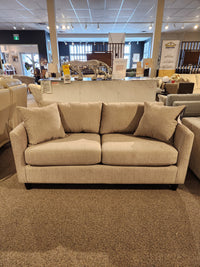 The Best Bayment Double Sofa Bed features beige upholstery, two cushions, and back pillows for stylish, comfortable sleep.