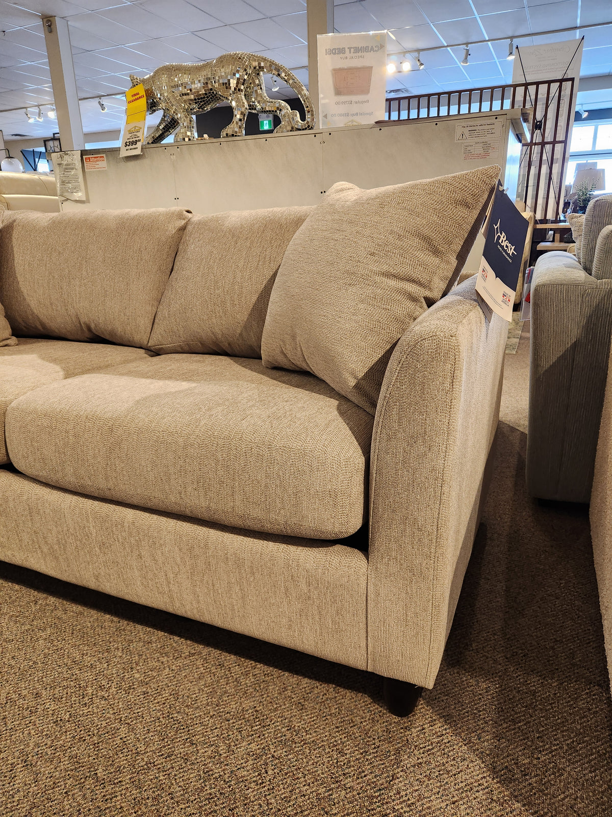 The Bayment Double Sofa Bed by Best features beige upholstery, angled armrests, and a memory foam mattress.