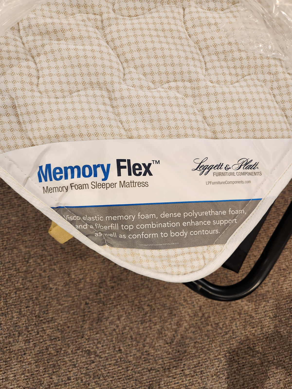 Corner of a Bayment Double Sofa Bed by Best with product label and description on the fabric surface.