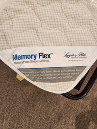 Corner of a Bayment Double Sofa Bed by Best with product label and description on the fabric surface.