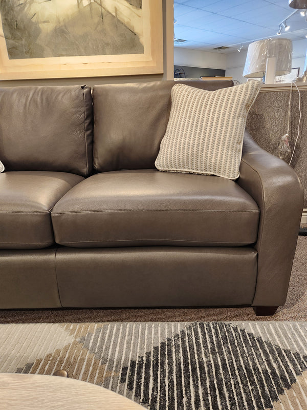 La-z-boy 638-620 Charlie apartment size sofa with two patterned pillows on a textured rug in a bright living room.