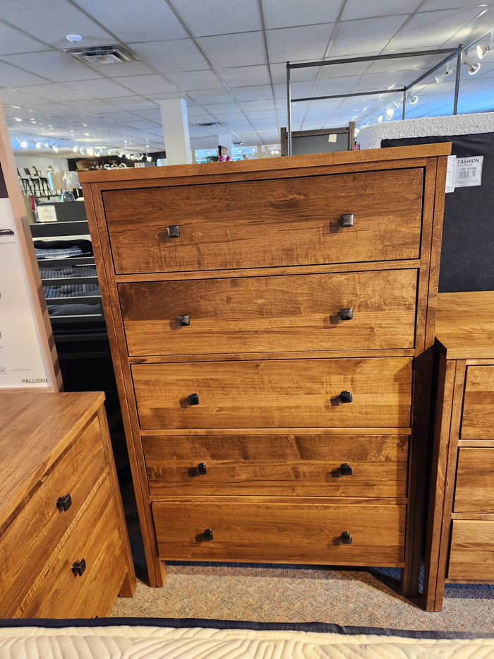 The Vokes 247 Saugeen 5 Drawer Chest pairs well with a rustic bedside table in the showroom.