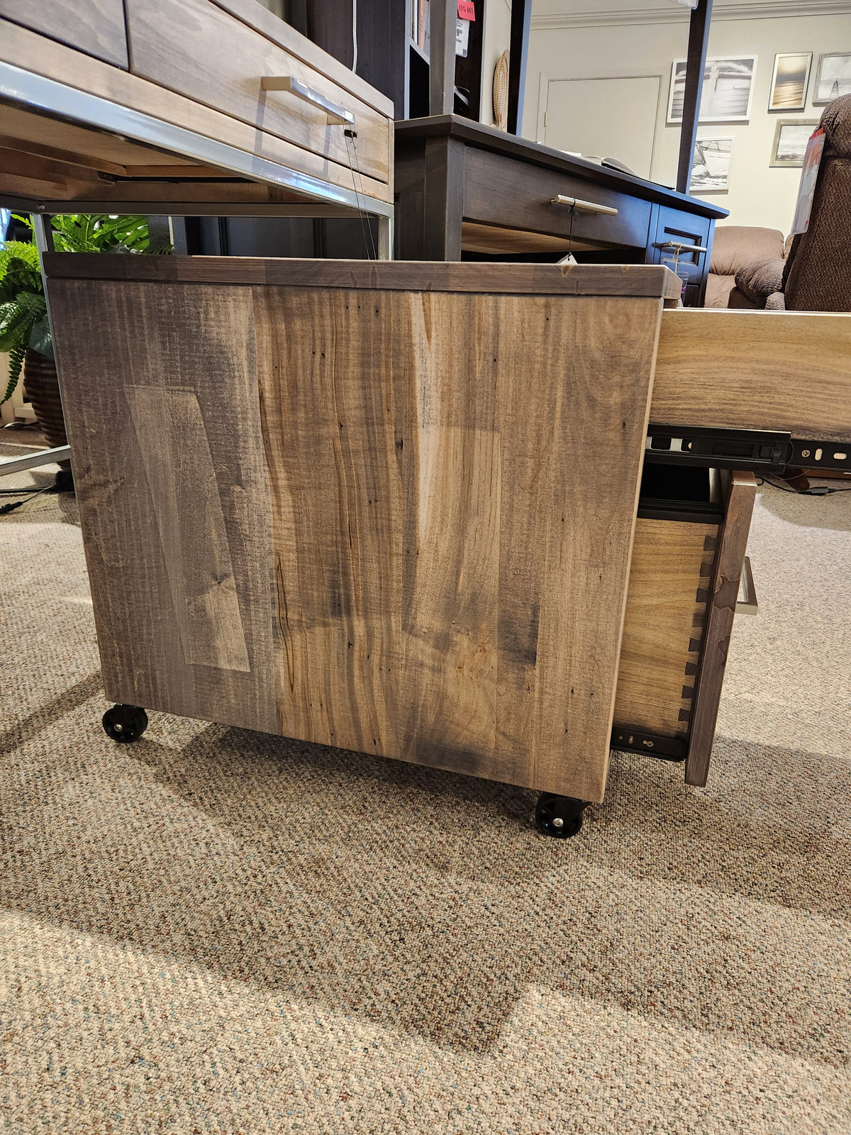 The Handstone EL2D Electra Rolling File Cabinet is partially pulled out from under a matching desk on a carpeted floor.