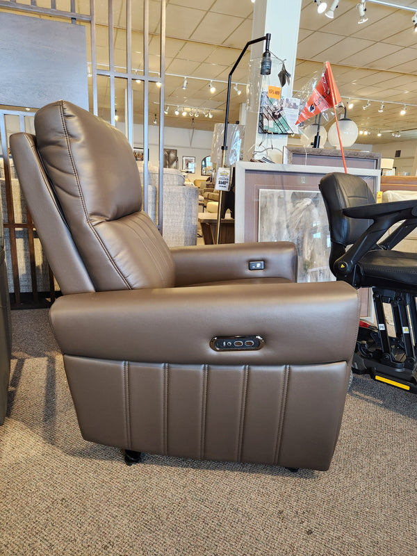 Golden Rec-PS Cinder Power Recliner, brown leather with control buttons and USB ports, shown in a furniture showroom.