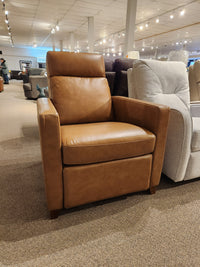 The Palliser 77171 Soren Push-Back Reclining Chair in tan leather with tapered wooden legs is on showroom display.