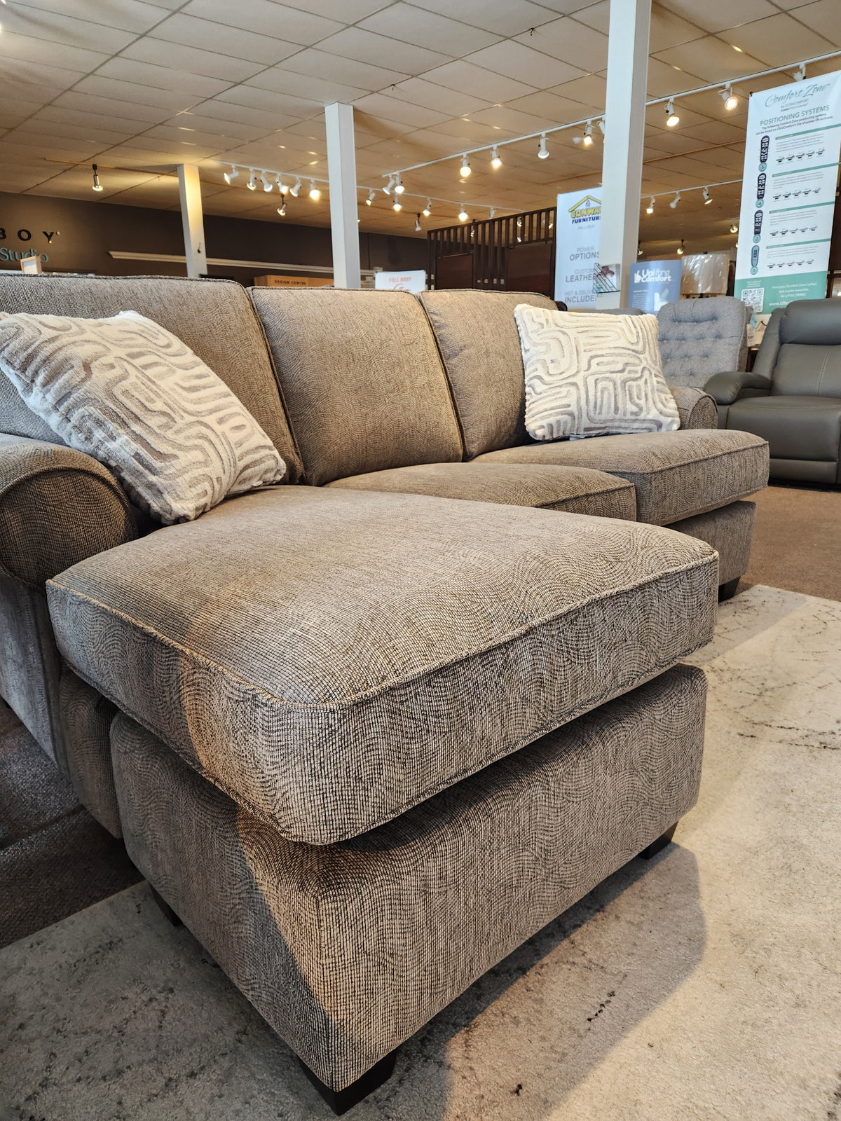 Canadian-made Decor-rest 2285 Sofa with Chaise in gray, sinuous spring construction, shown with patterned pillows.