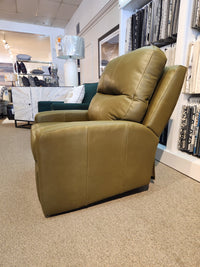 The Decor-rest M38505 Power Reclining Chair in green is shown with a headrest and fabric samples in the background.