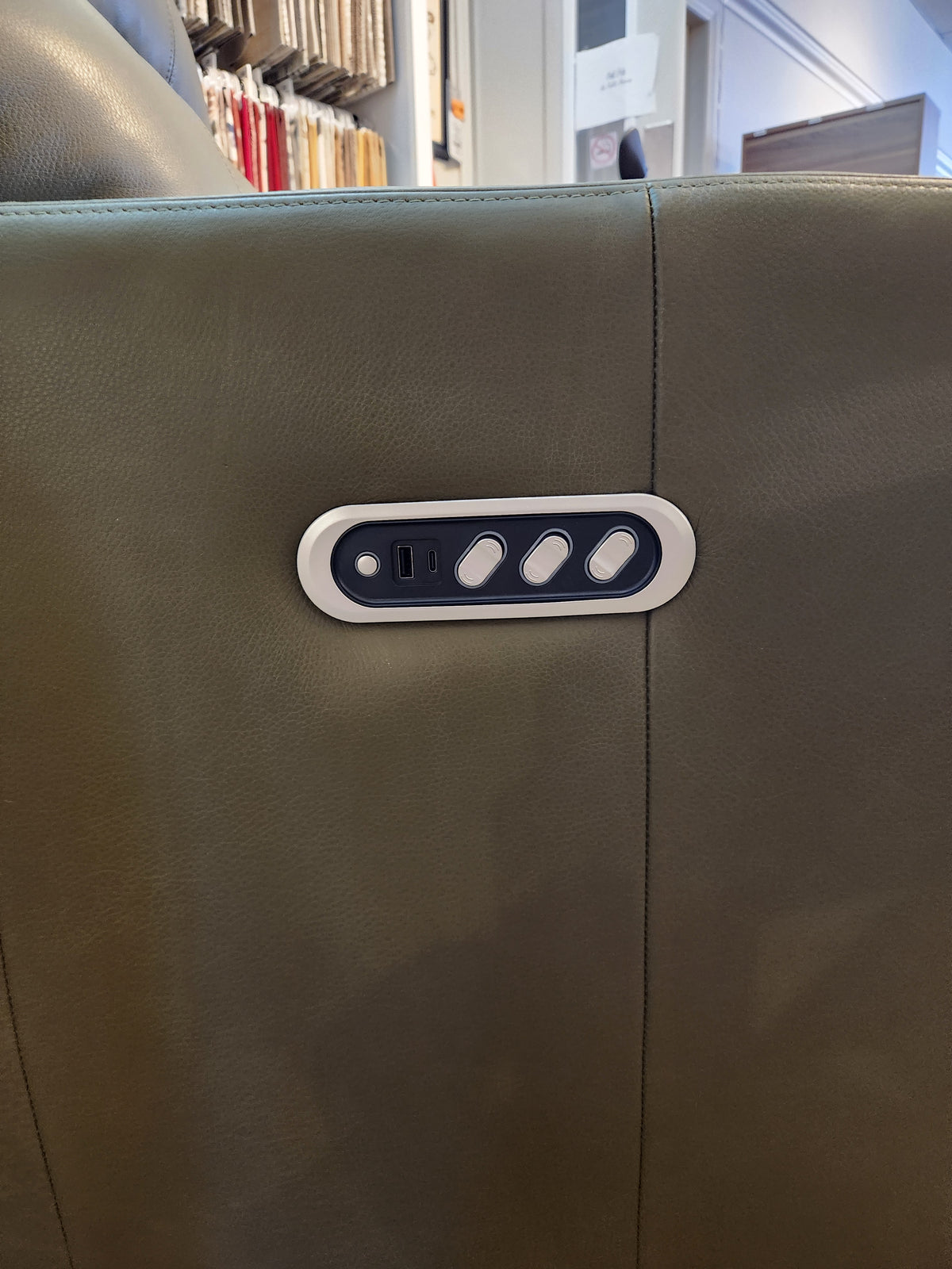 Close-up of control panel with three buttons and USB port on the Decor-rest M38505 Power Reclining Chair in green leather.