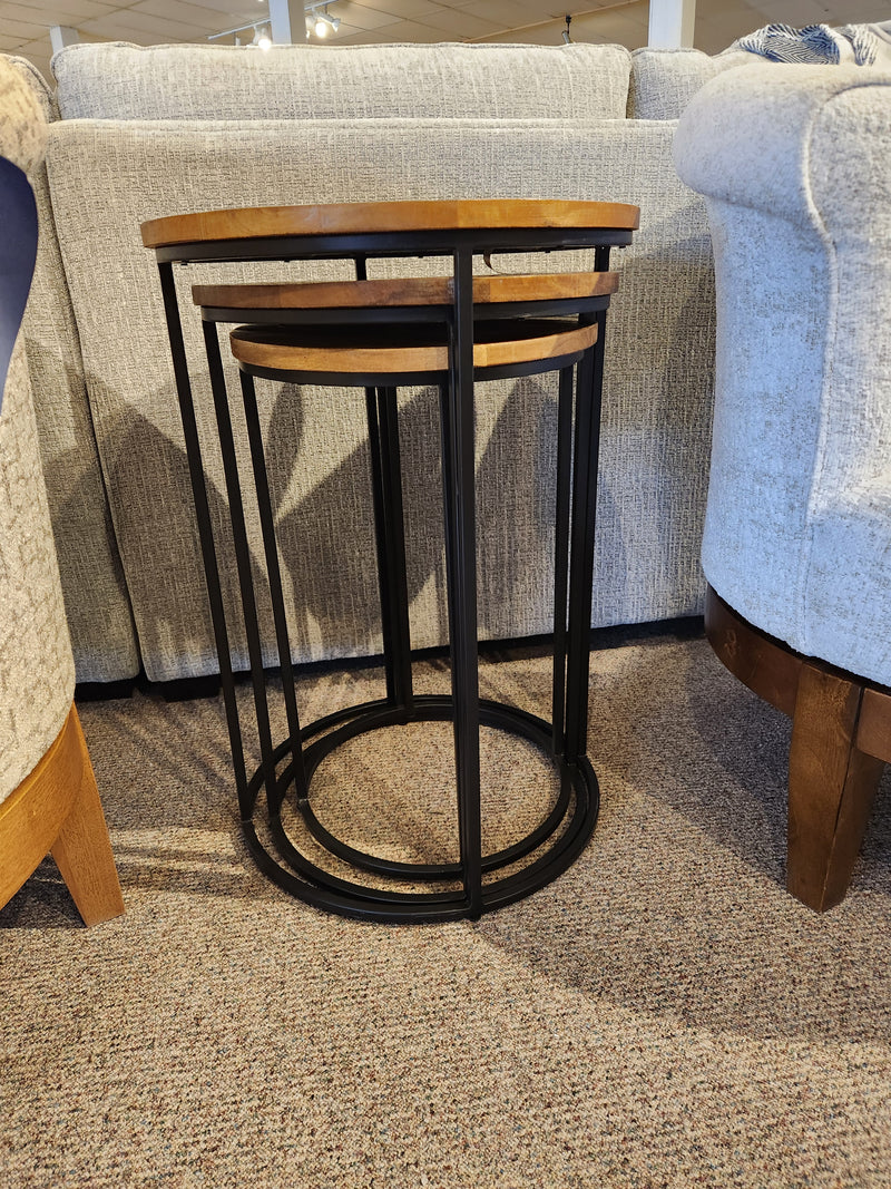 The Jofran 2330-Warneram Nesting Tables add rustic charm between sofas with wood tops and black frames.
