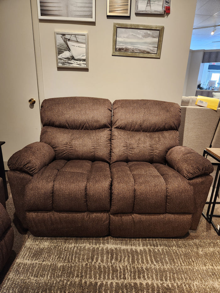 La-Z-Boy 766 Morrison Reclining Loveseat with plush cushions and armrests, on a patterned rug in a living room.