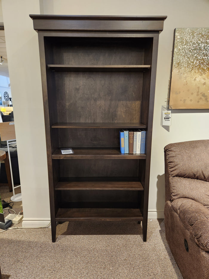 The Handstone ST80 Stockholm Bookcase with sleek lines stands next to a brown sofa.