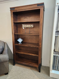 The Handstone CH80 Chattanooga 80" Bookcase in maple mocha with adjustable shelves holds a clock and driftwood.