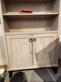 The Handstone CU80D-Cumberland Bookcase features vertical storage, two cabinet doors, and a shelf for books.