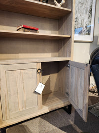 Handstone CU80D-Cumberland Bookcase in light wood features adjustable shelves; a red book sits on one shelf.