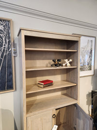Handstone CU80D-Cumberland Bookcase with 3 shelves, vertical storage, red book, decor pieces, and open cabinet below.