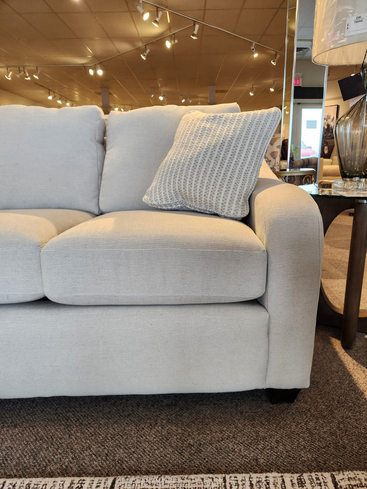 Light gray La-z-boy 638-610 Charlie Sofa with detached back pillows and a textured pillow shown under showroom lighting.
