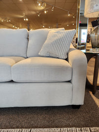 Light gray La-z-boy 638-610 Charlie Sofa with detached back pillows and a textured pillow shown under showroom lighting.