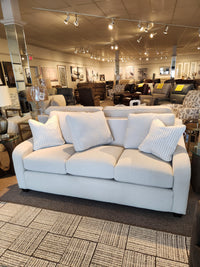 The La-z-boy 638-610 Charlie Sofa, featuring detached back pillows, is displayed in a modern furniture showroom.