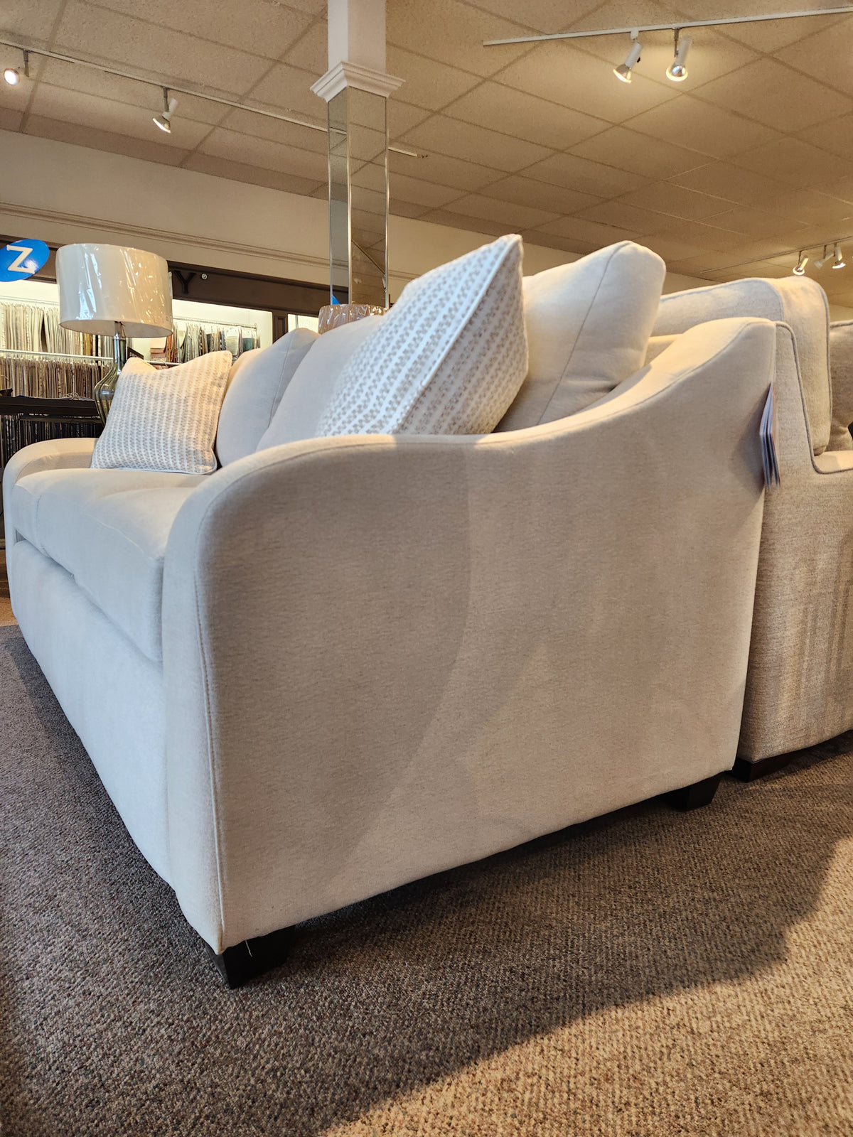 The La-z-boy 638-610 Charlie Sofa features detached back pillows and is shown on a carpeted showroom floor.