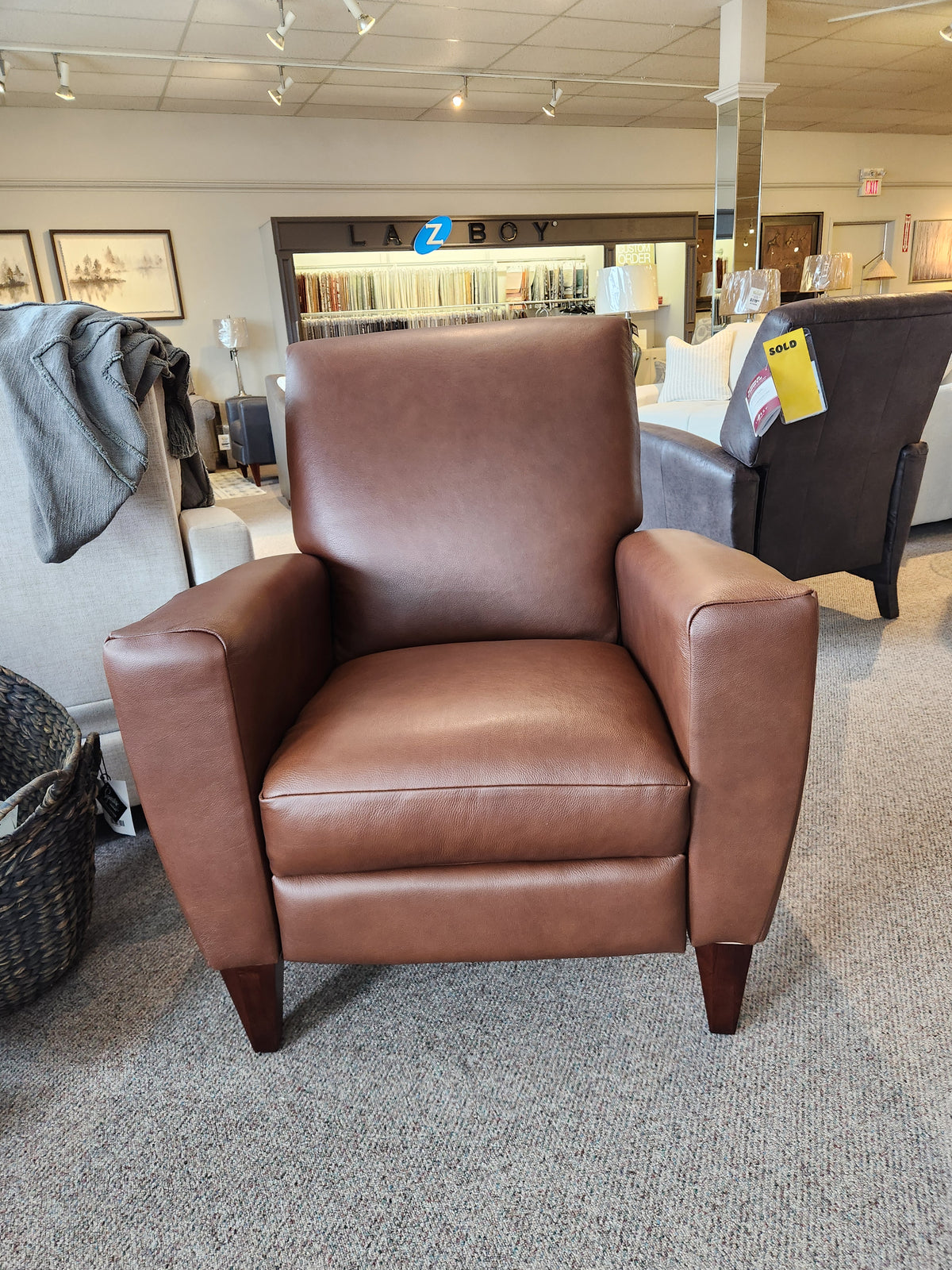 La-Z-Boy 431 Scarlett High-Leg Recliner on carpet in showroom, with chairs and La-Z-Boy sign in background.