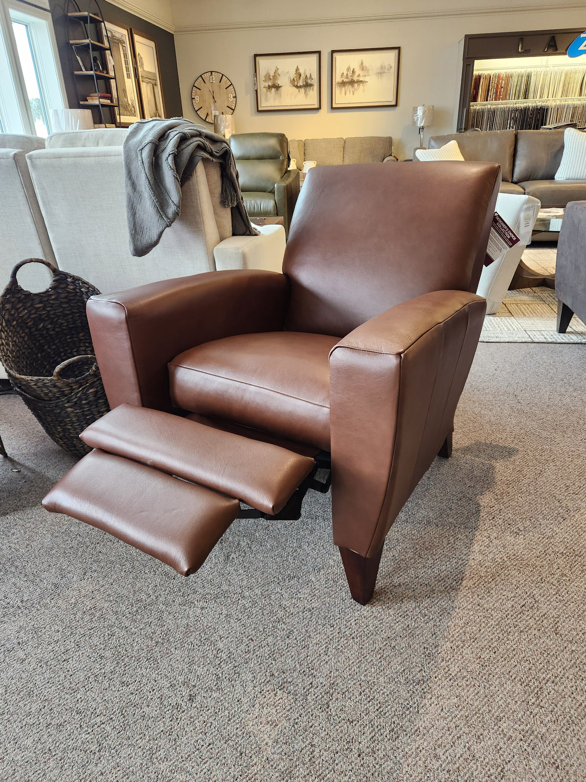 La-z-boy 431 Scarlett High-Leg Recliner in brown leather, shown with footrest extended in a living room showroom.