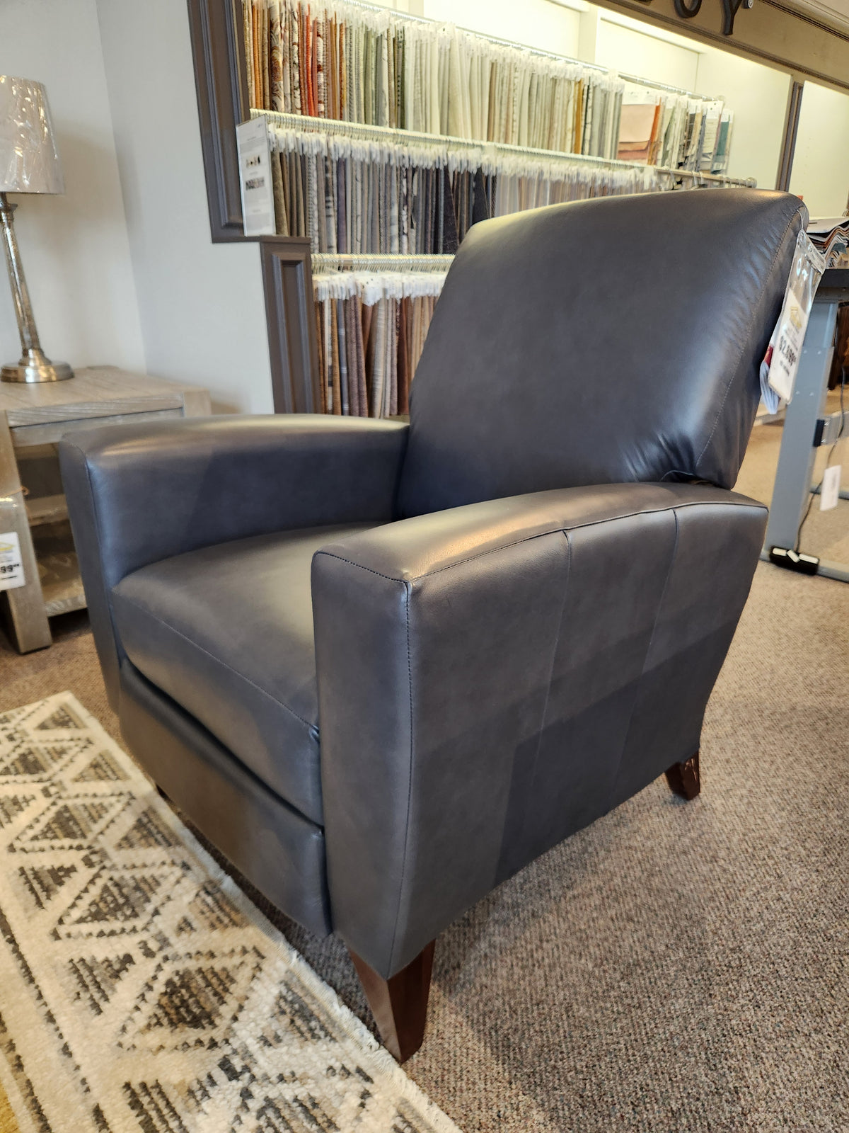 La-Z-Boy 431 Scarlett High-Leg Recliner in dark gray leather with wooden legs, shown with fabric samples.