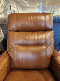 Close-up of a La-Z-Boy 807 Baron Rocker Recliner in brown, showcased in a showroom with art on the walls behind.