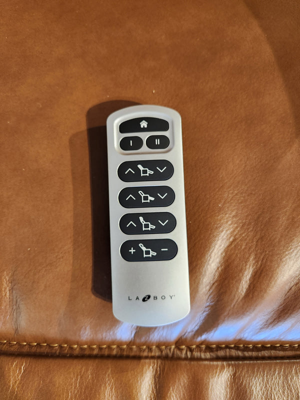 La-Z-Boy 807 Baron Power Wall-a-Way Recliner remote with seven black buttons on brown leather upholstery.