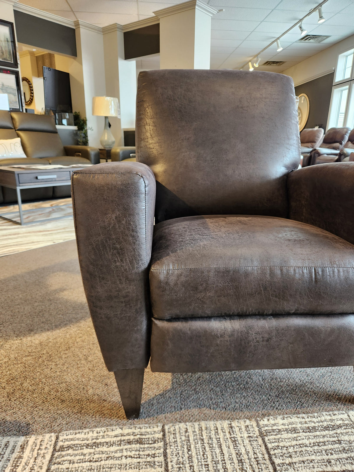The La-z-boy 431 Scarlett High-Leg Recliner in dark brown sits on carpet in a well-lit showroom.